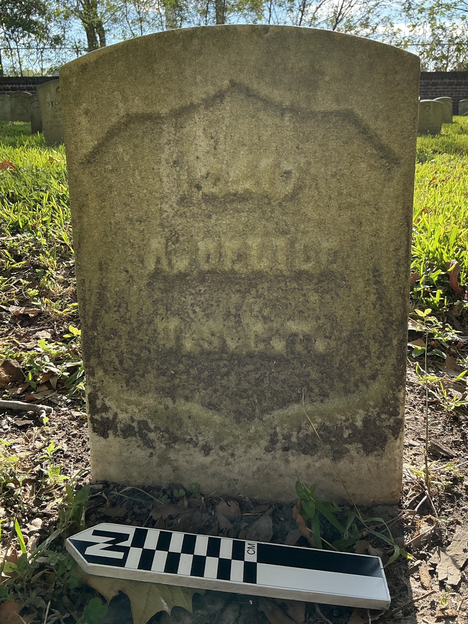 Extra image of historic upright marble headstone with recessed shield face.