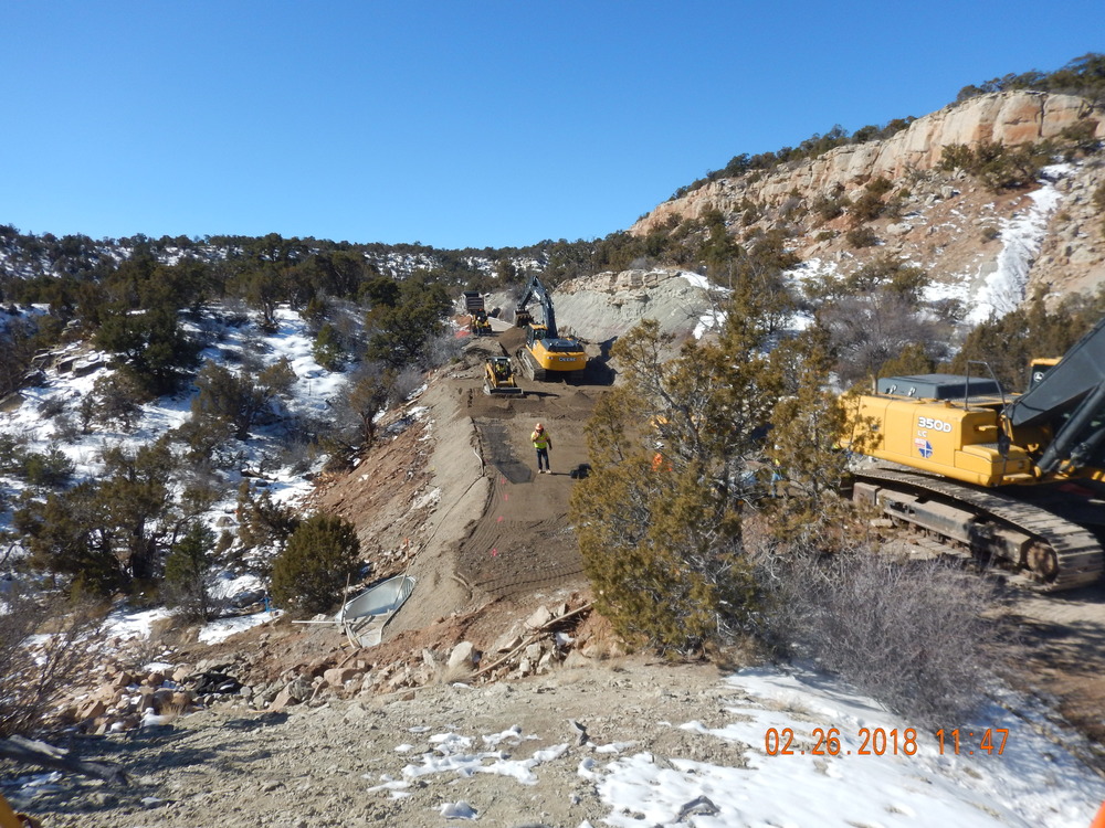 People at work with heavy equipment on Rim Rock Drive between Artists Point and Highland View. Culvert and road base as of February 26, 2018.