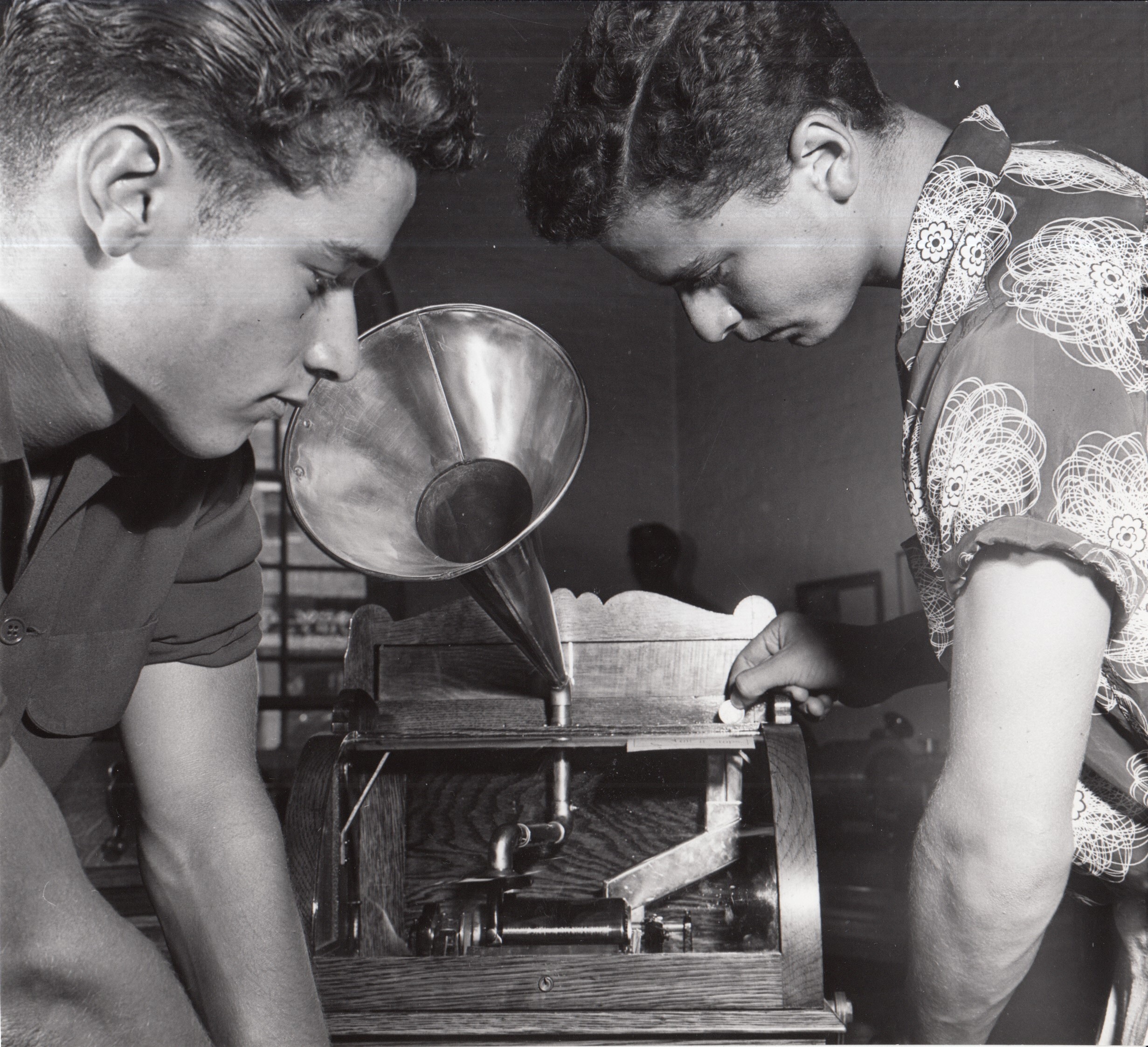 Michael Diamond and Richard Weinick examining coin-operated Edison cylinder phonograph display at Edison Museum.