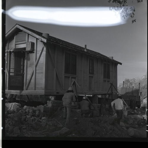 Zion Inn cabin being loaded on trailer by Kaibab-Paiute Tribe prior to removal.