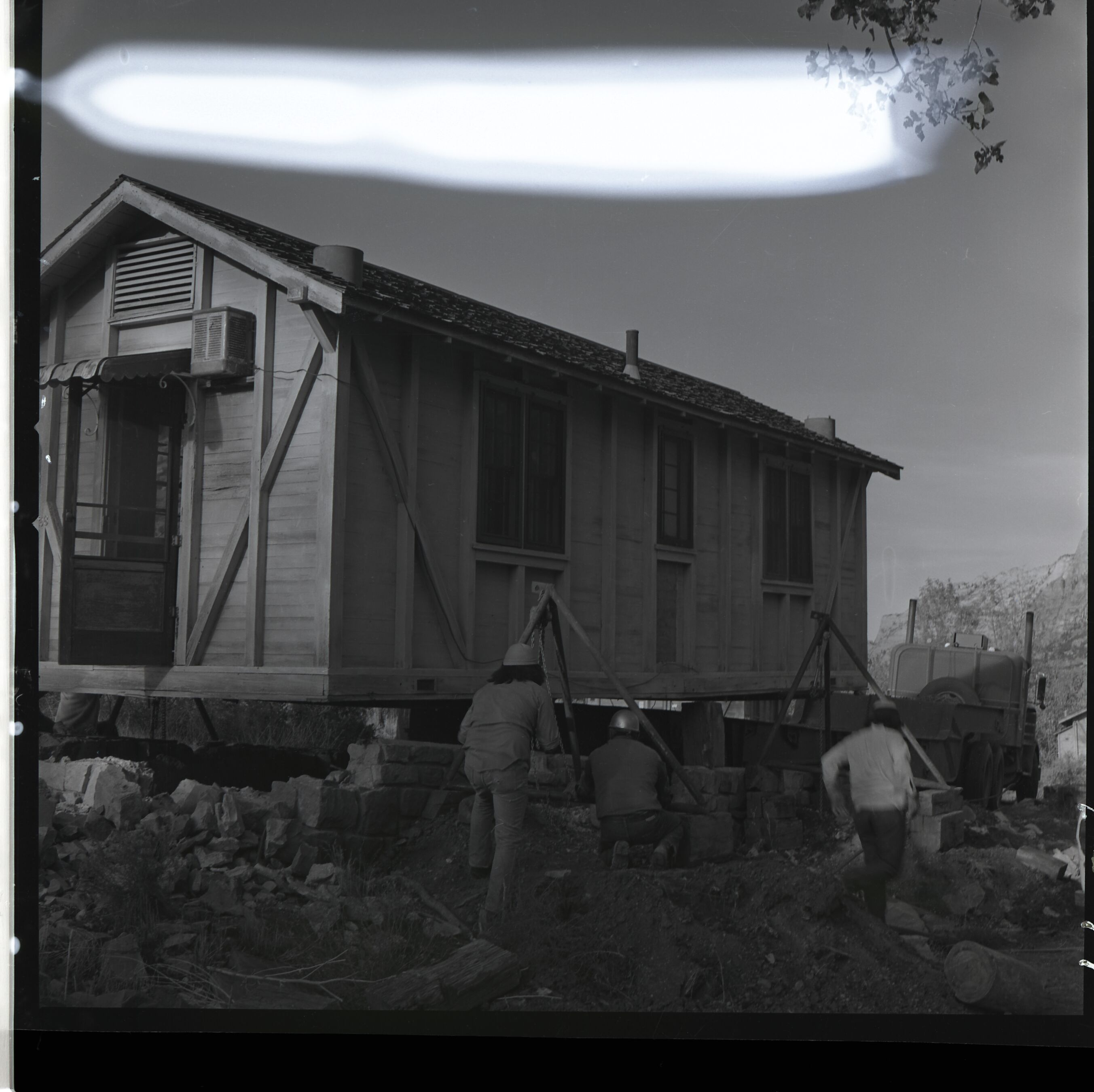 Zion Inn cabin being loaded on trailer by Kaibab-Paiute Tribe prior to removal.