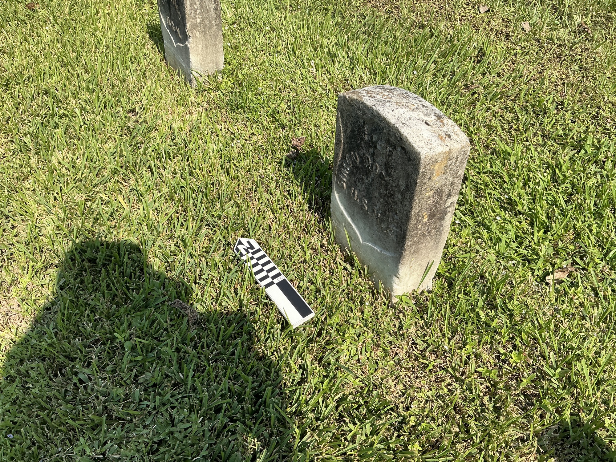 Extra image of historic upright marble headstone with recessed shield with recessed lettering face.