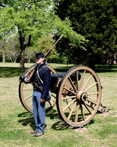Park ranger in Civil War Union soldier costume poses in Shiloh National Cemetery