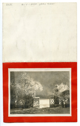 Black and white photograph of gate covered in snow with red border.