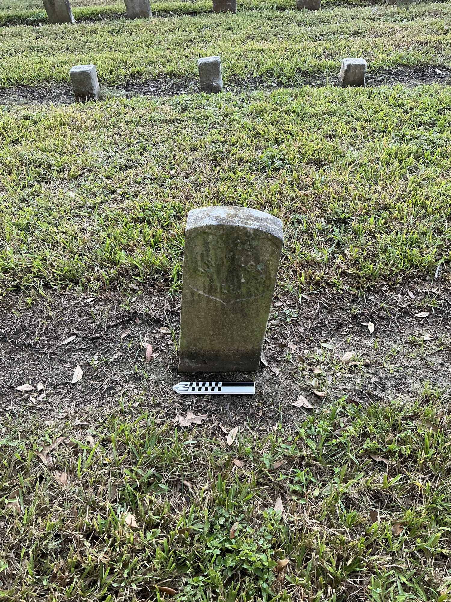Extra image of historic upright marble headstone with recessed shield face.