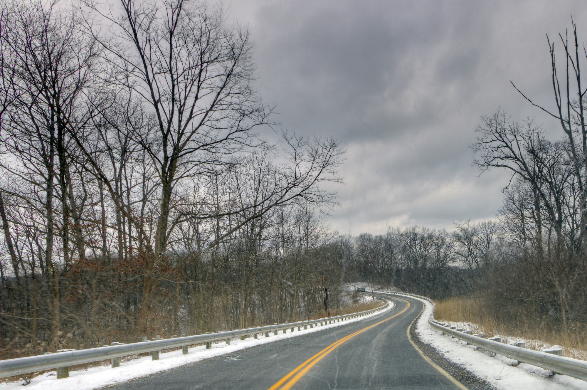 A curvy road through a snowy valley.