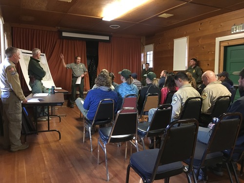 Search and rescue staff receive briefing about operations. 