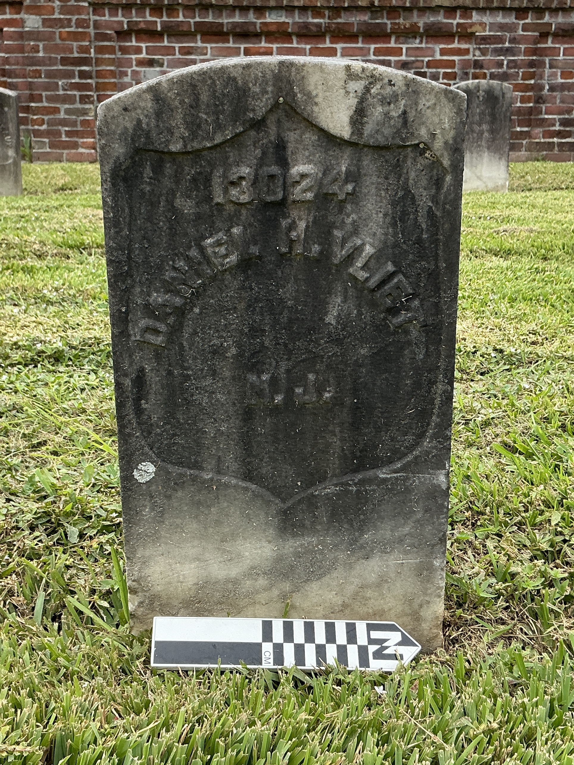 Extra image of historic upright marble headstone with recessed shield face.
