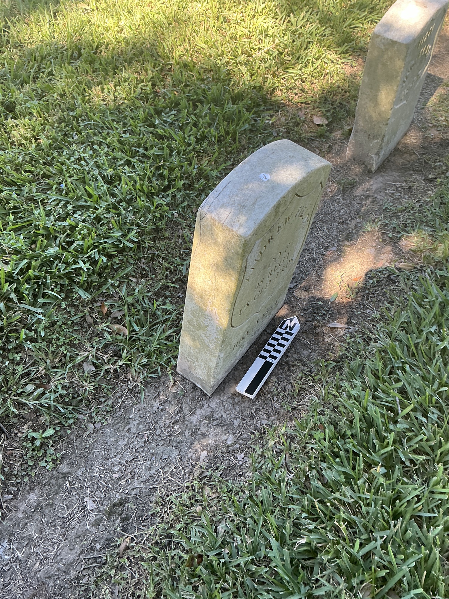 Extra image of historic upright marble headstone with incised shield face.