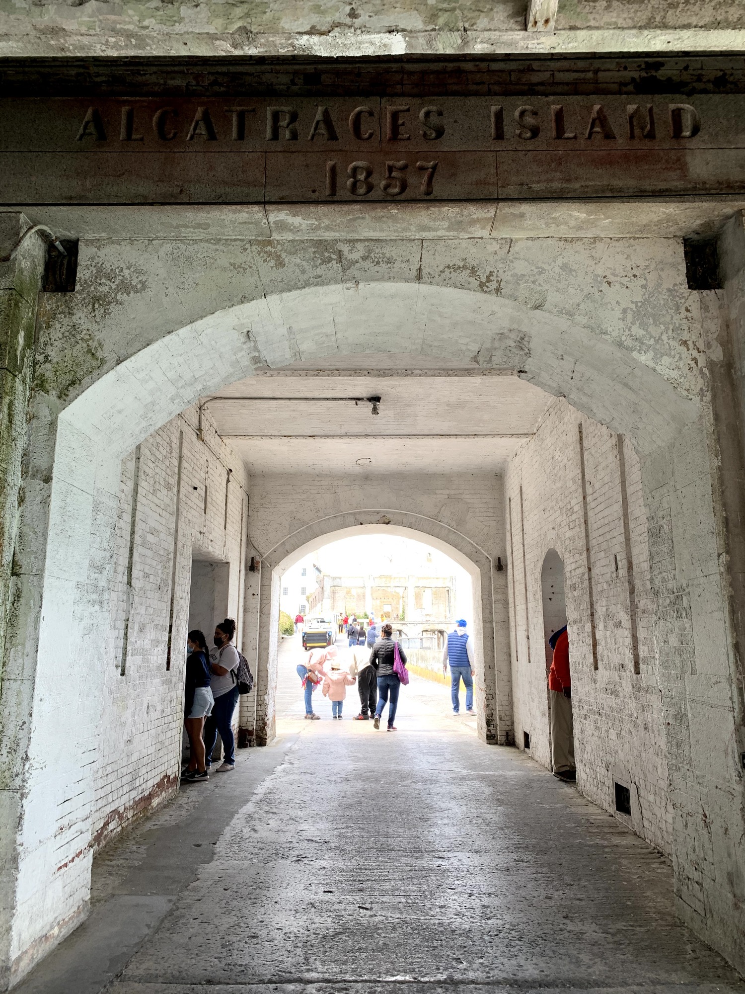 The top of a white brick archway reveals a sign that reads "Alcatraces Island 1857"