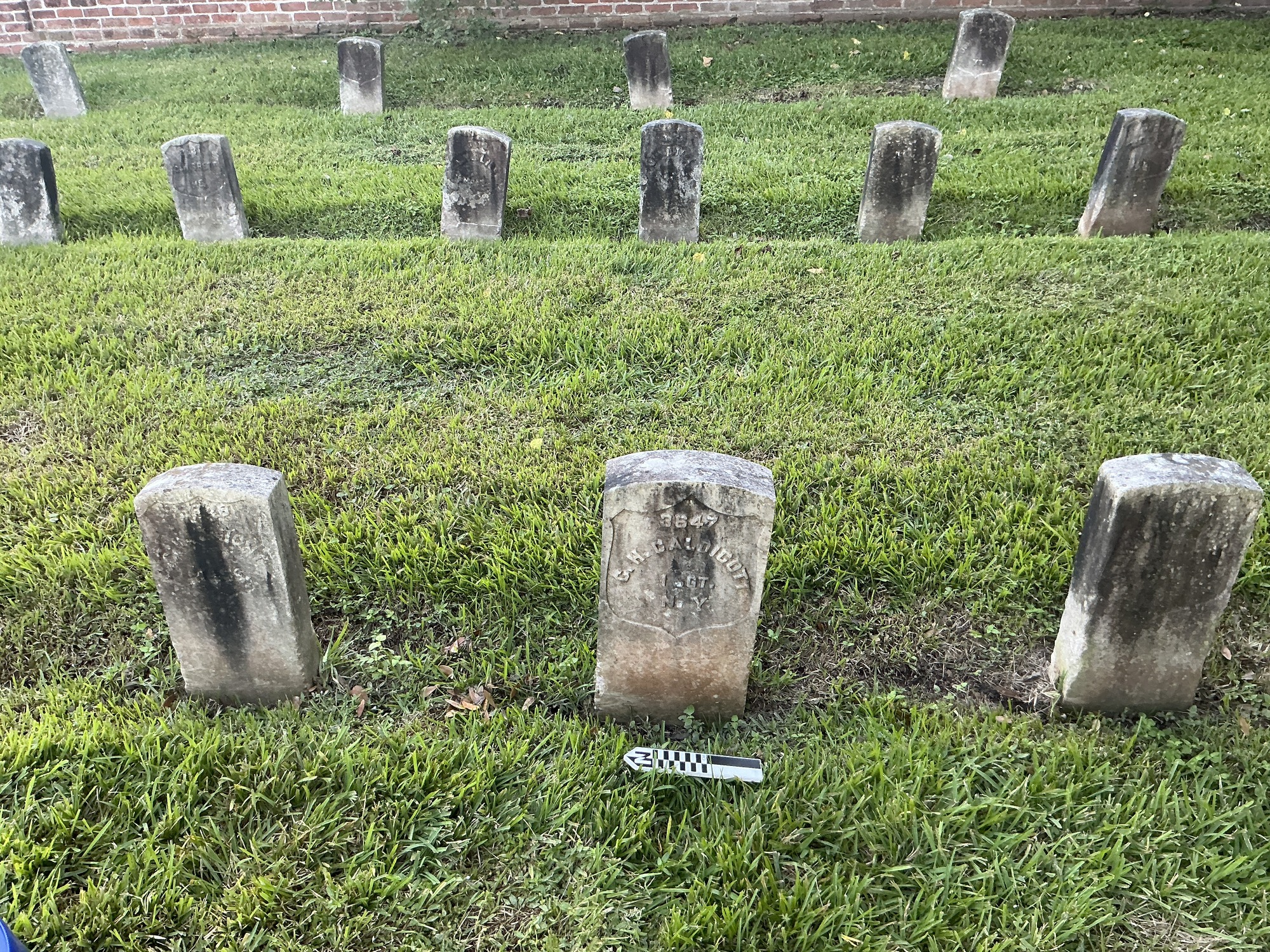 Extra image of historic upright marble headstone with recessed shield face.