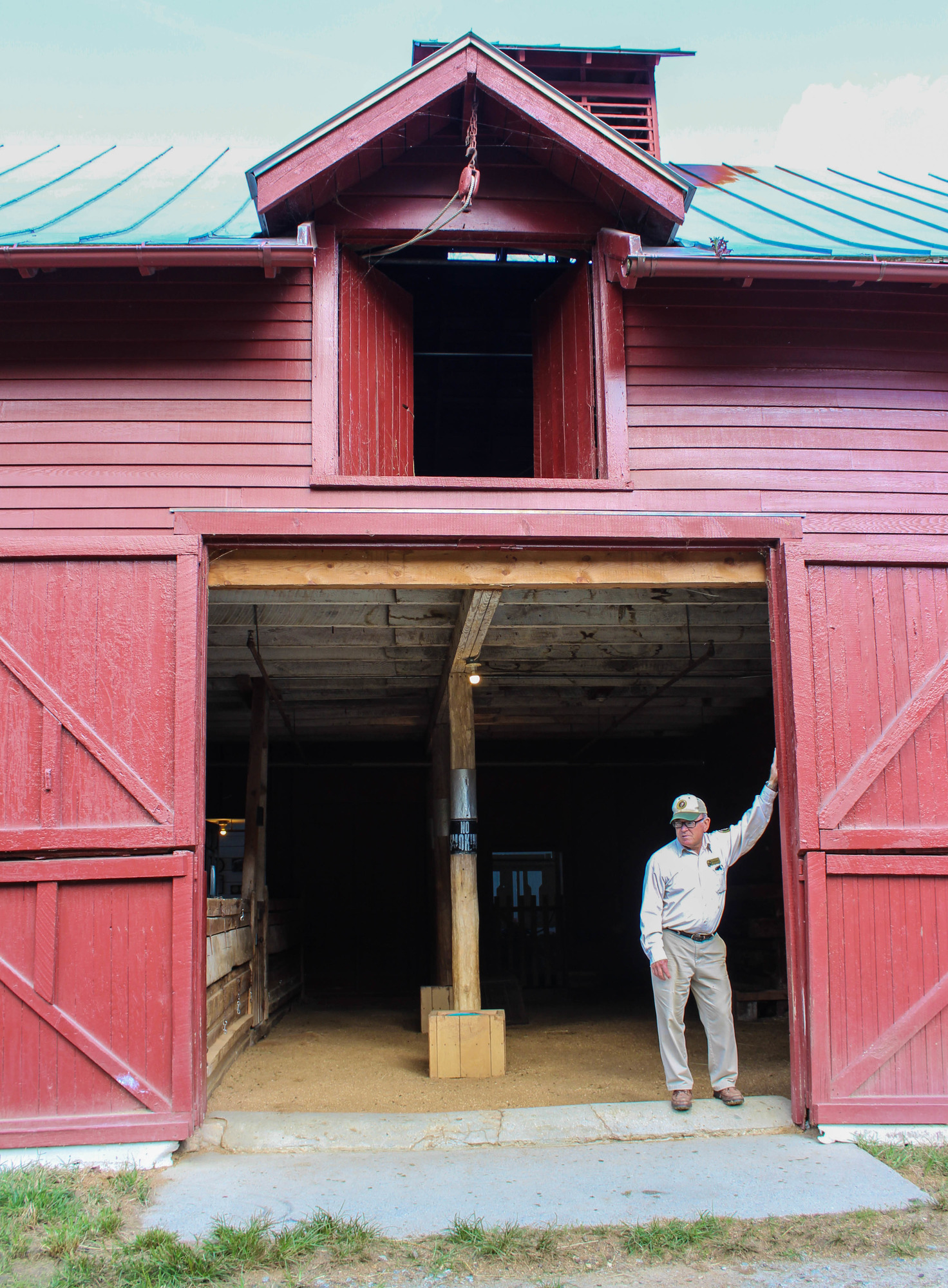 Volunteer standing in a barn door