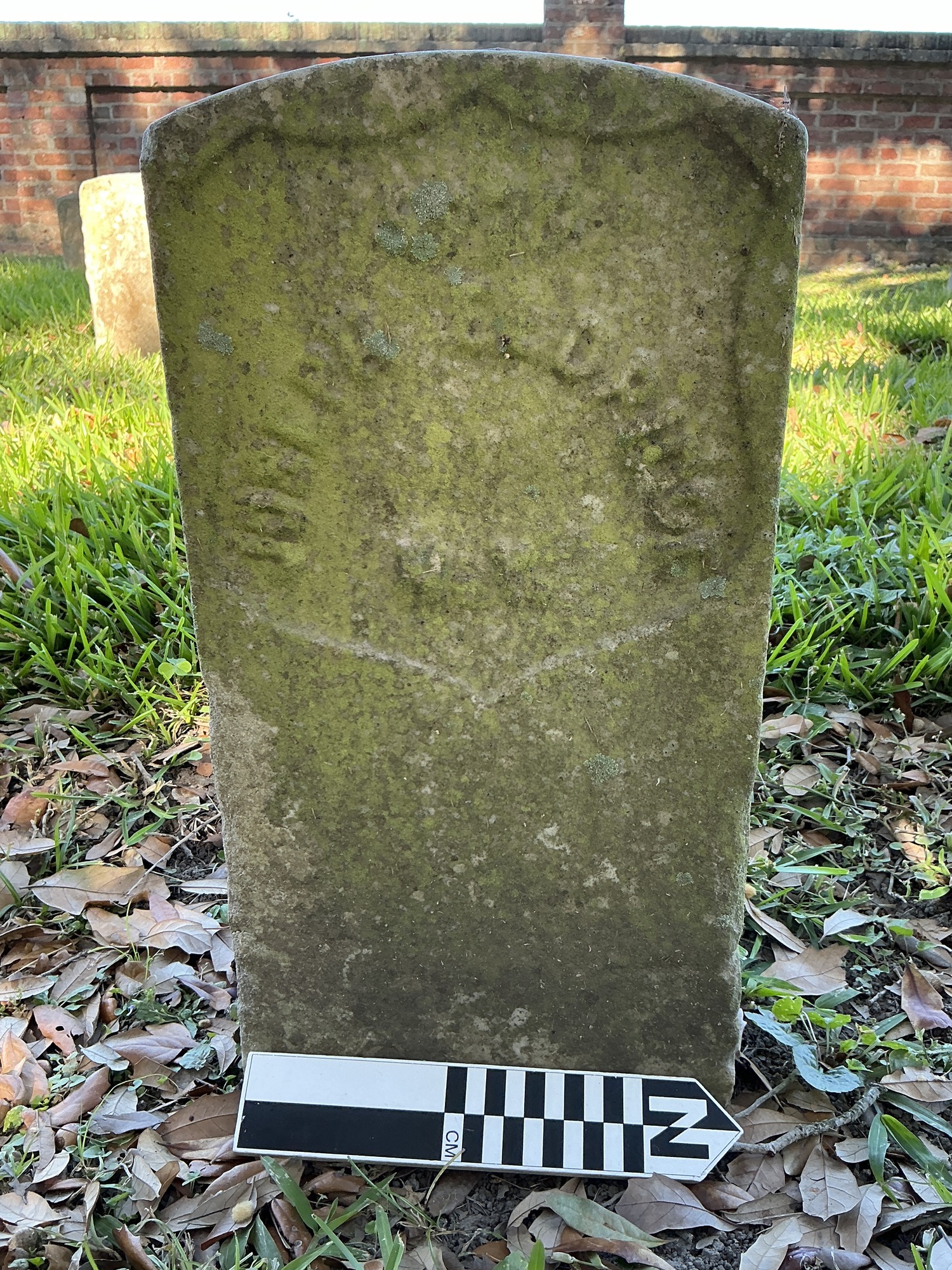 Extra image of historic upright marble headstone with recessed shield face.