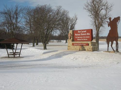 Entrance sign with snow.