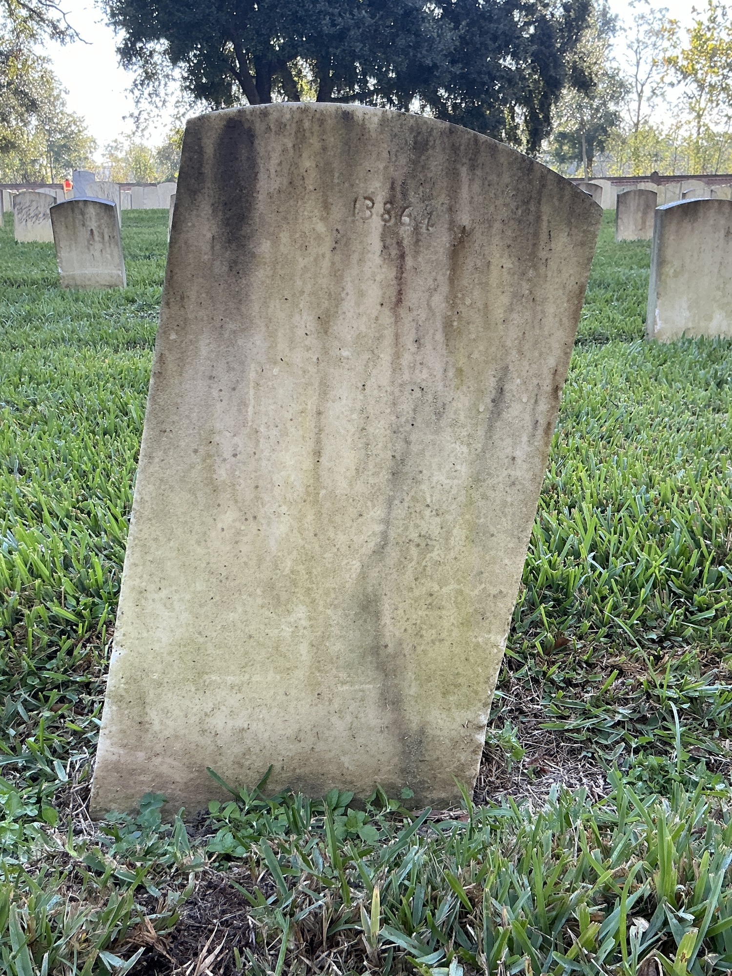 Back of upright marble headstone with flat face.
