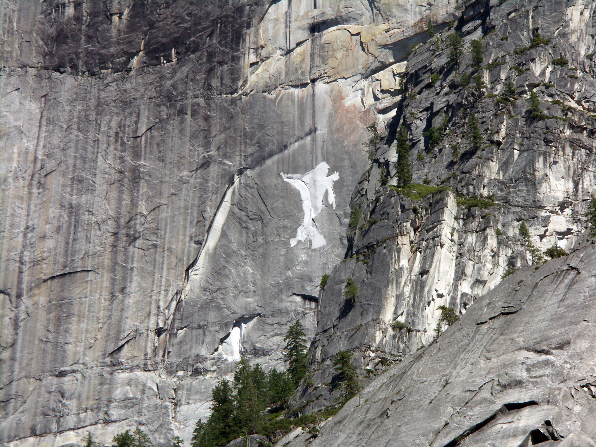 A close perspective of light colored rock fall source area on cliff.