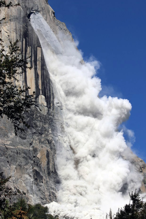 A close perspective of a very large, thick dust cloud billow from the southeast face of El Capitan.