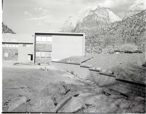 Parking area construction and newly completed retaining wall at rear of Mission 66 Visitor Center and Museum.