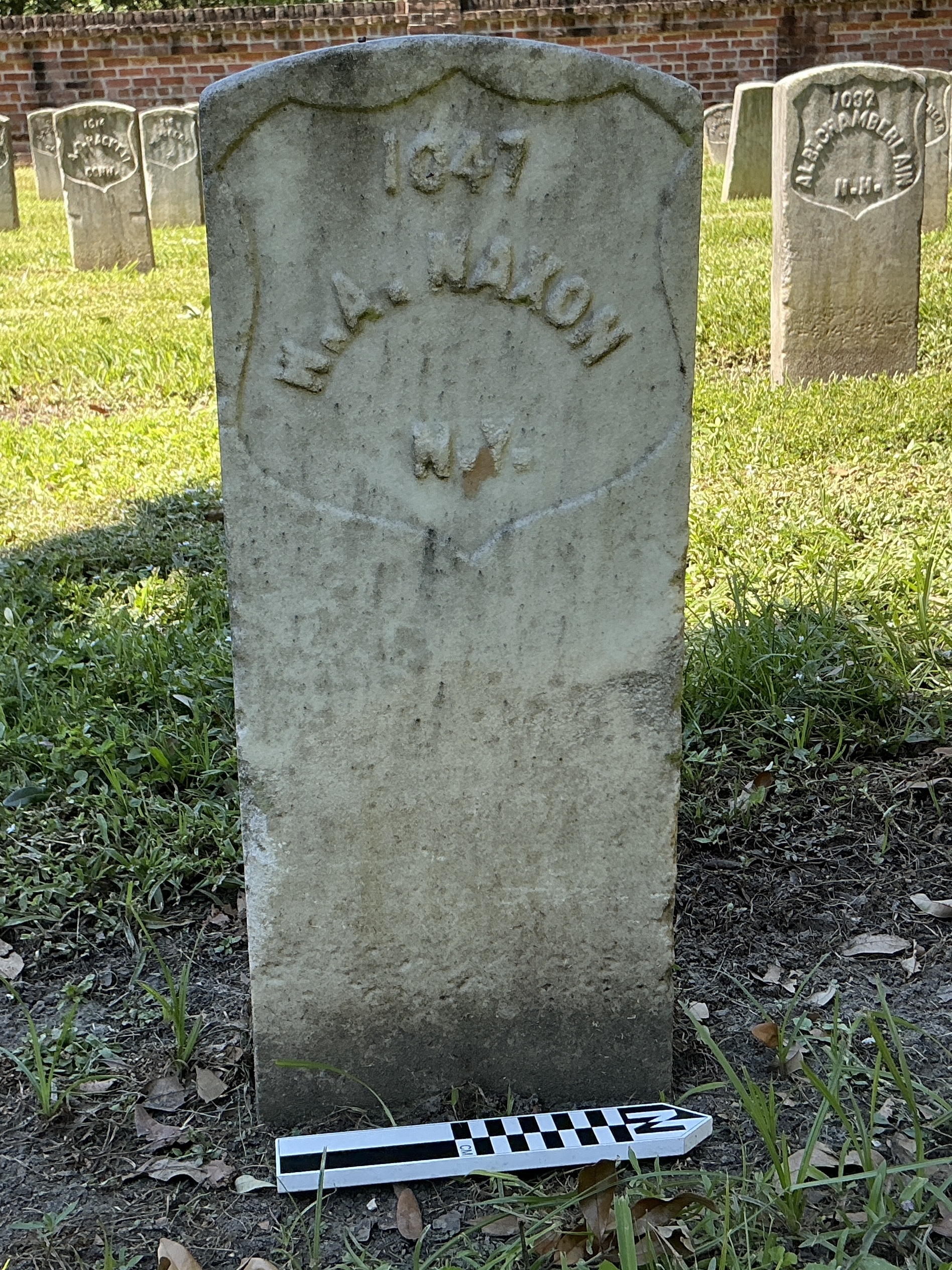 Extra image of historic upright marble headstone with recessed shield face.