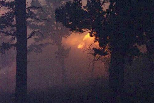 Night photos of a house burning during the Long Mesa fire in Mesa Verde National Park, July-August 2002