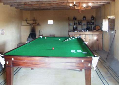 Billiards helped travelers and employees cope with boredom, idleness, and loneliness. Journals and diaries mention that cards and gemes of backgammon, chess, and checkers were played to ease the long days and nights. Susan Magoffin exclaimed that "I hear the cackling of chickens at such a rate sometimes I shall not be surprised to hear of a cock-pit." William Bent's son George, recalled that "across one end of the room ran a counter or bar, over which drinkables were served." The company's 1839 ledger shows a diverse assortment of drink; 12 boxes claret wine, 37 gallons brandy, and 58 gallons of rum. Lt. James Abert used the room as an art studio, positioning a Cheyenne model "upon the billiard table." The man "sat perfectly motionless" until the painting was completed and then asked that his name "Bear Above" be written underneath.