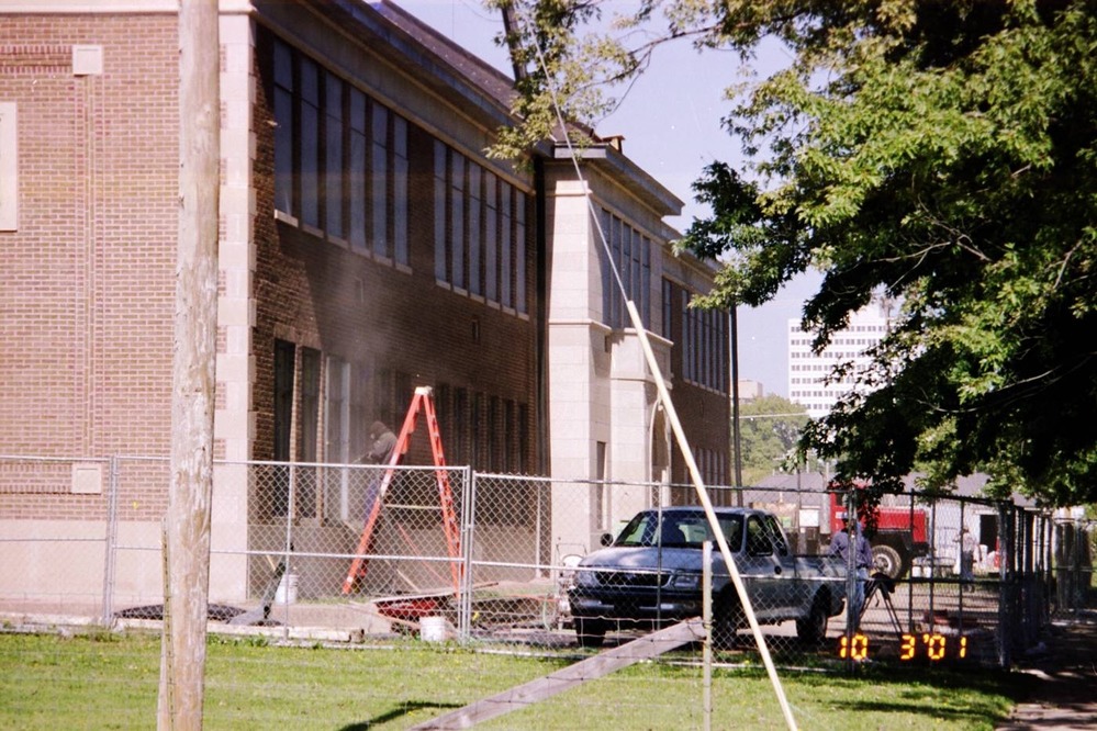 A worker sandblasts the window frames in the "Legacy" gallery.