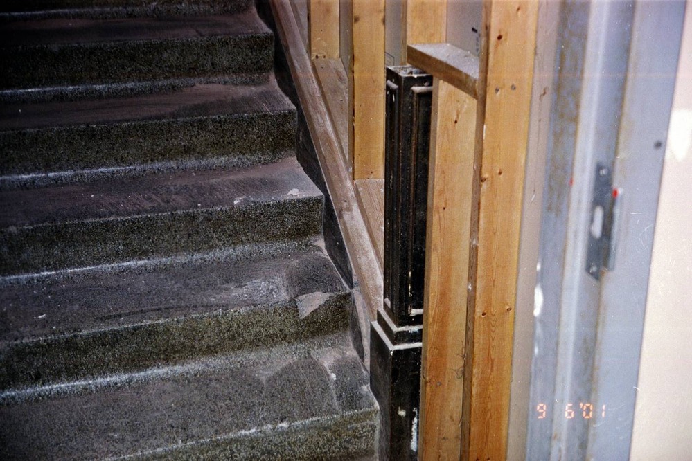 Original terazzo steps leading to the second floor on the north end of the building. The newel post is original. The wall was added at a later date to meet fire codes.