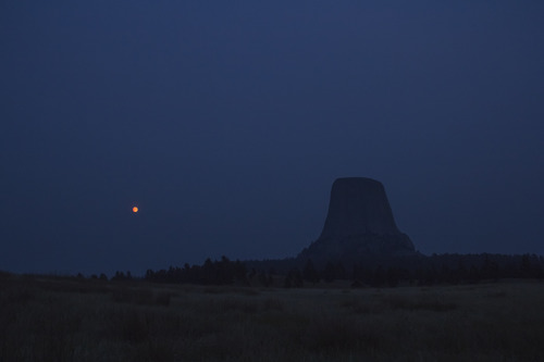 Devils Tower at night with a full moon.