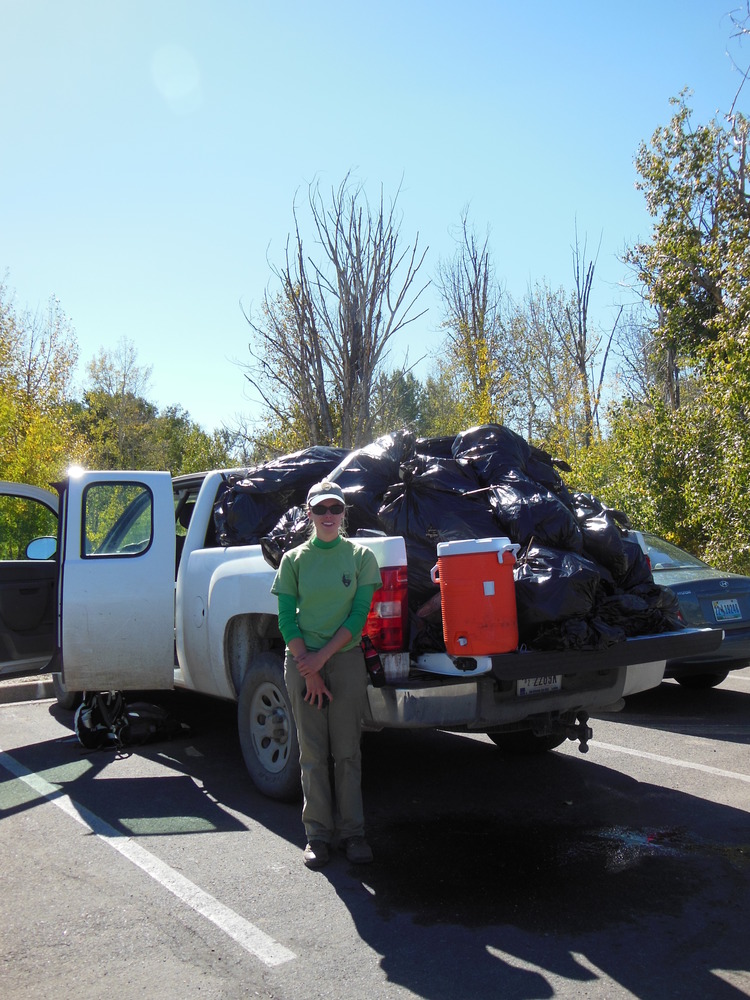Volunteer with trash from Cottonwood Creek Cleanup, 2013