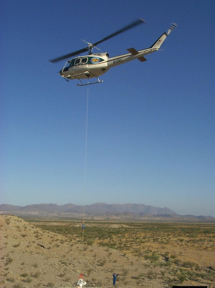 Alamosaurus bones become airborne! On the morning of May 7, 2001, the air show began. A helicopter transported the seven remaining neck bones from the excavation site to a flatbed truck waiting on a park road.