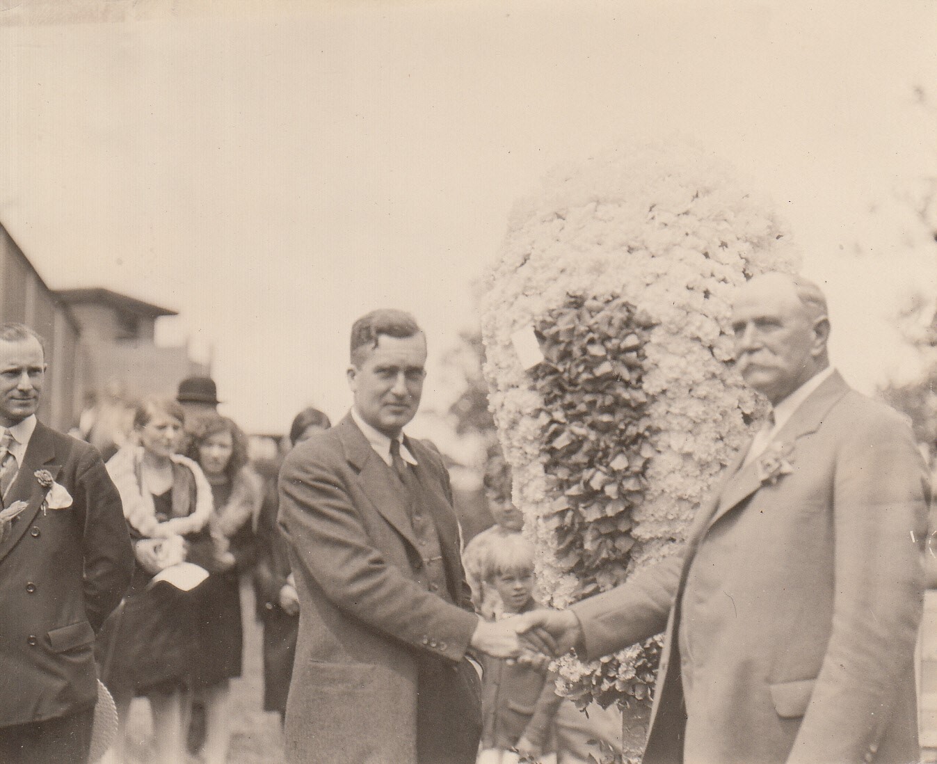 Charles Edison greeting unidentified man at ceremony initiating Postal Service from Menlo Park.