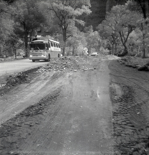 Shuttle bus driving alongside road work long the scenic canyon drive near the Grotto.