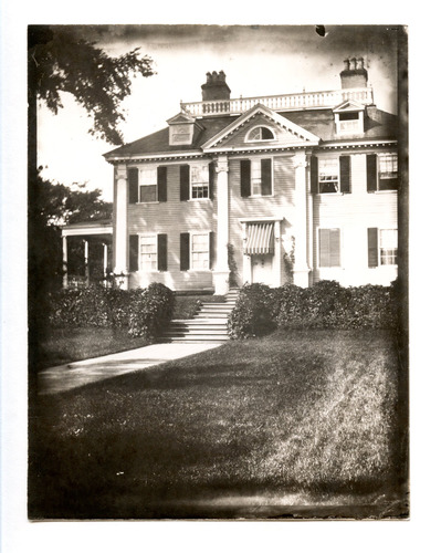 Black and whit photograph of facade of Georgian mansion.