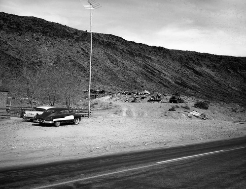 Signs and a collection of old cars and trucks at the 101 Ranch. On State Route 15 (now state Route 9) the approach road to Zion.