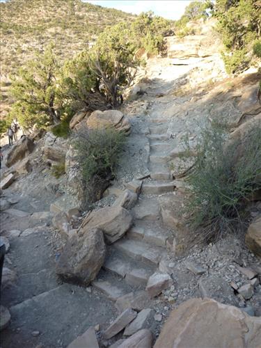 ARRA funded trail workers shaping rocks for retaining walls, steps, and checks at Colorado National Monument in Summer 2009.