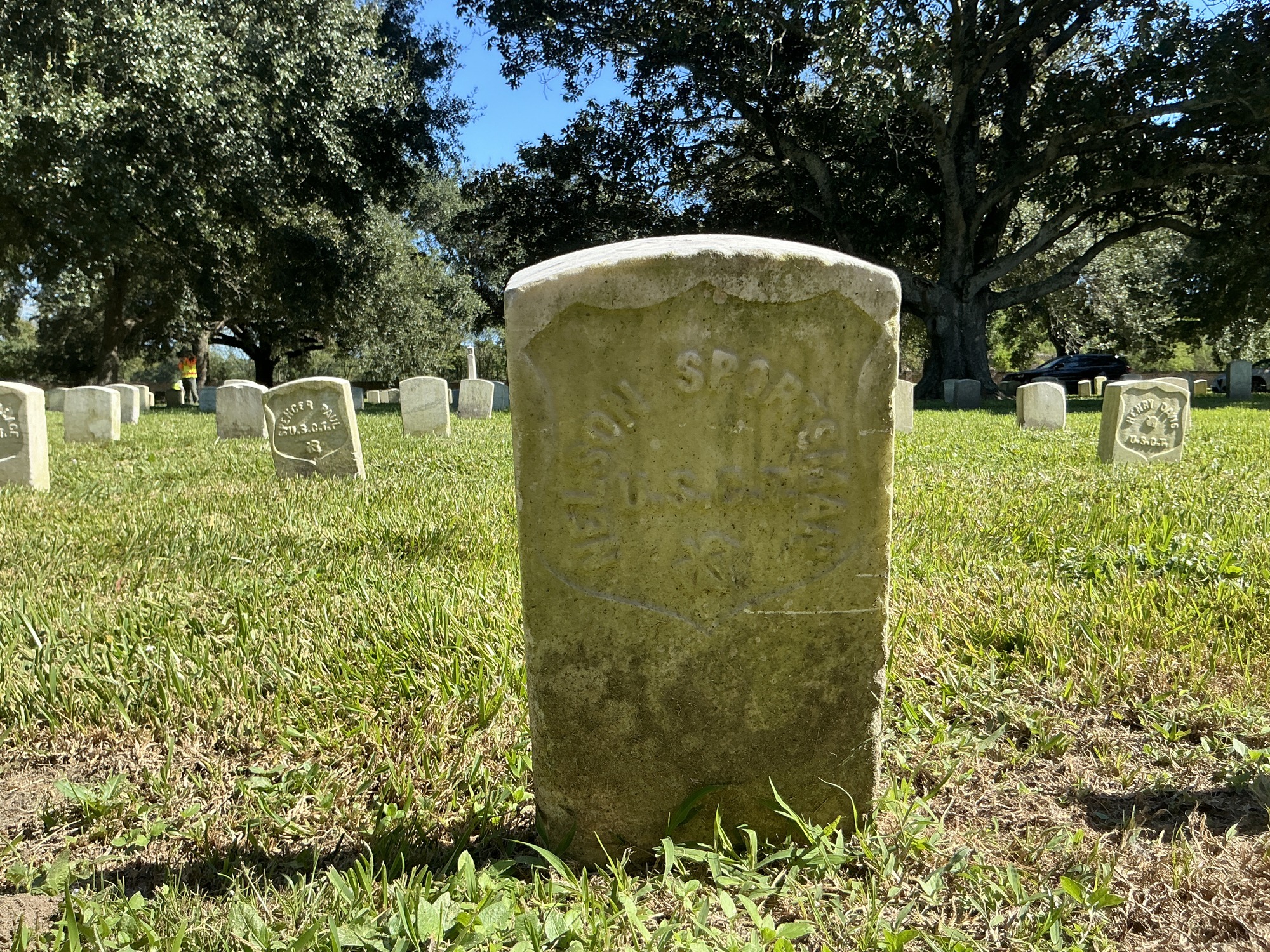 Back of historic upright marble headstone with recessed shield face.
