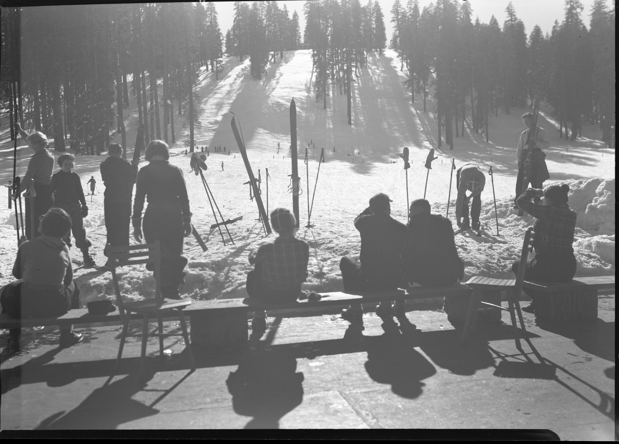 Group of skiiers facing ski slopes at Badger Pass