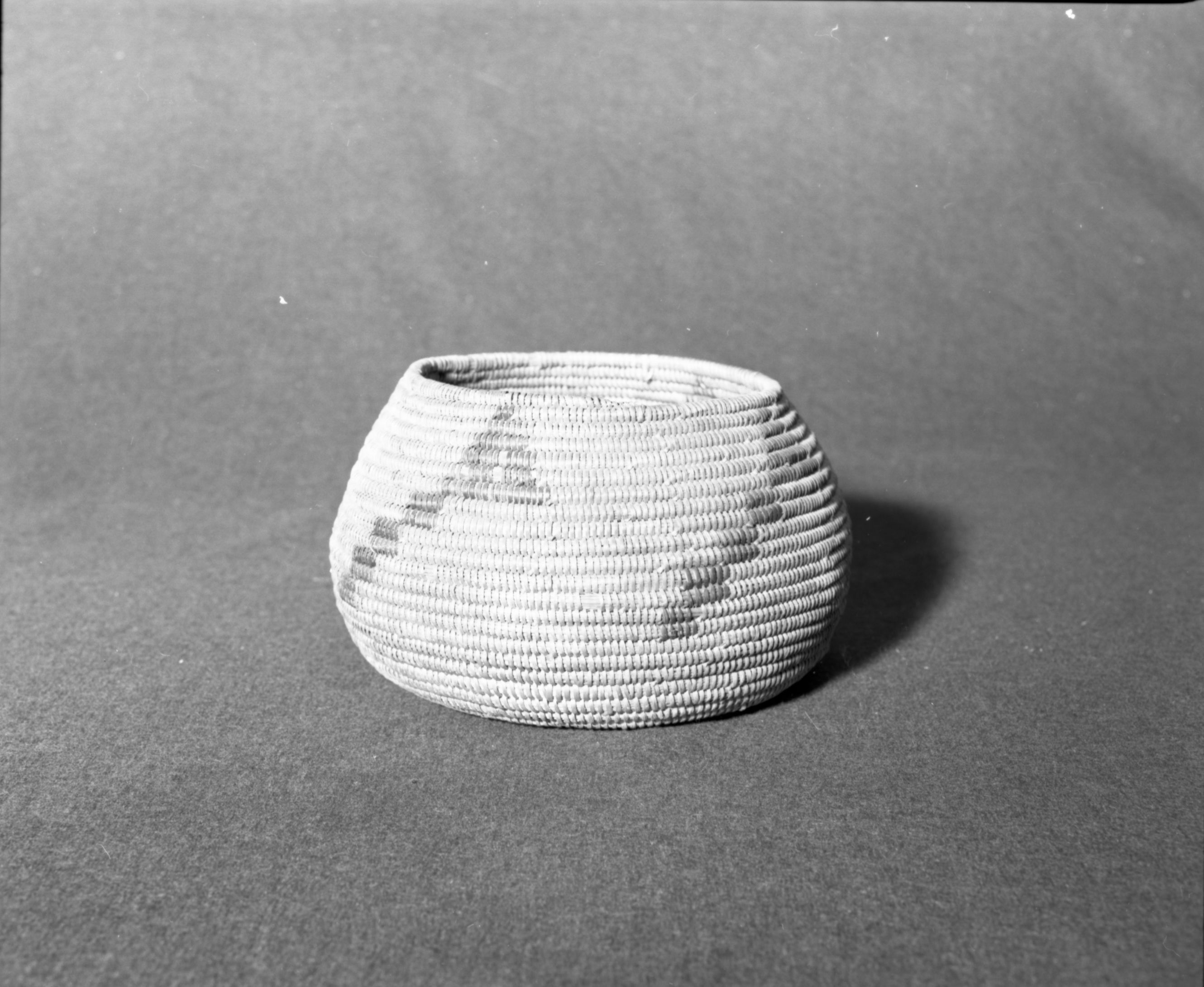 Marie Rozier Collection, Catalog No. 210. Object: Southern California basket. Dimensions: 8 x 5". Materials: Juncus, bunchgrass, split sumac. Technology: Rightward coil direction; non-interlocking stitch; fag ends flipped and concealed by next stitch; moving ends same. Collection History: Gift of Eleann Veale. Basket was in her family in 1908. Her family had been in San Diego since 1885. Photographed by Michael Dixon, December 1982. Catalogued by Craig Bates and Barbara Beroza. Yosemite Collections, National Park Service.