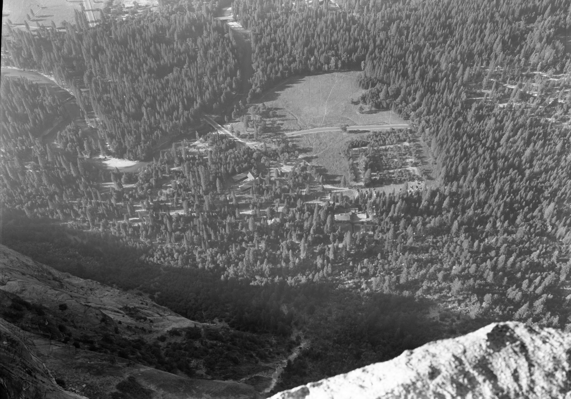 Curry parking area from Glacier Point showing cars in open and under trees.