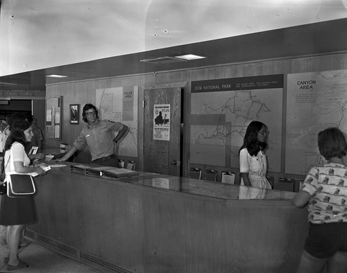 Student Conservation Association (SCA) volunteers Mike Prescott and Carol Ann Lau at Visitor Center information desk.