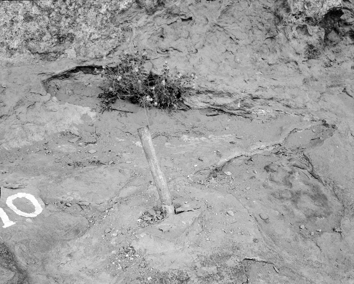 Vandalism on Canyon Overlook Trail. Image shows damaged pipe set in cement.