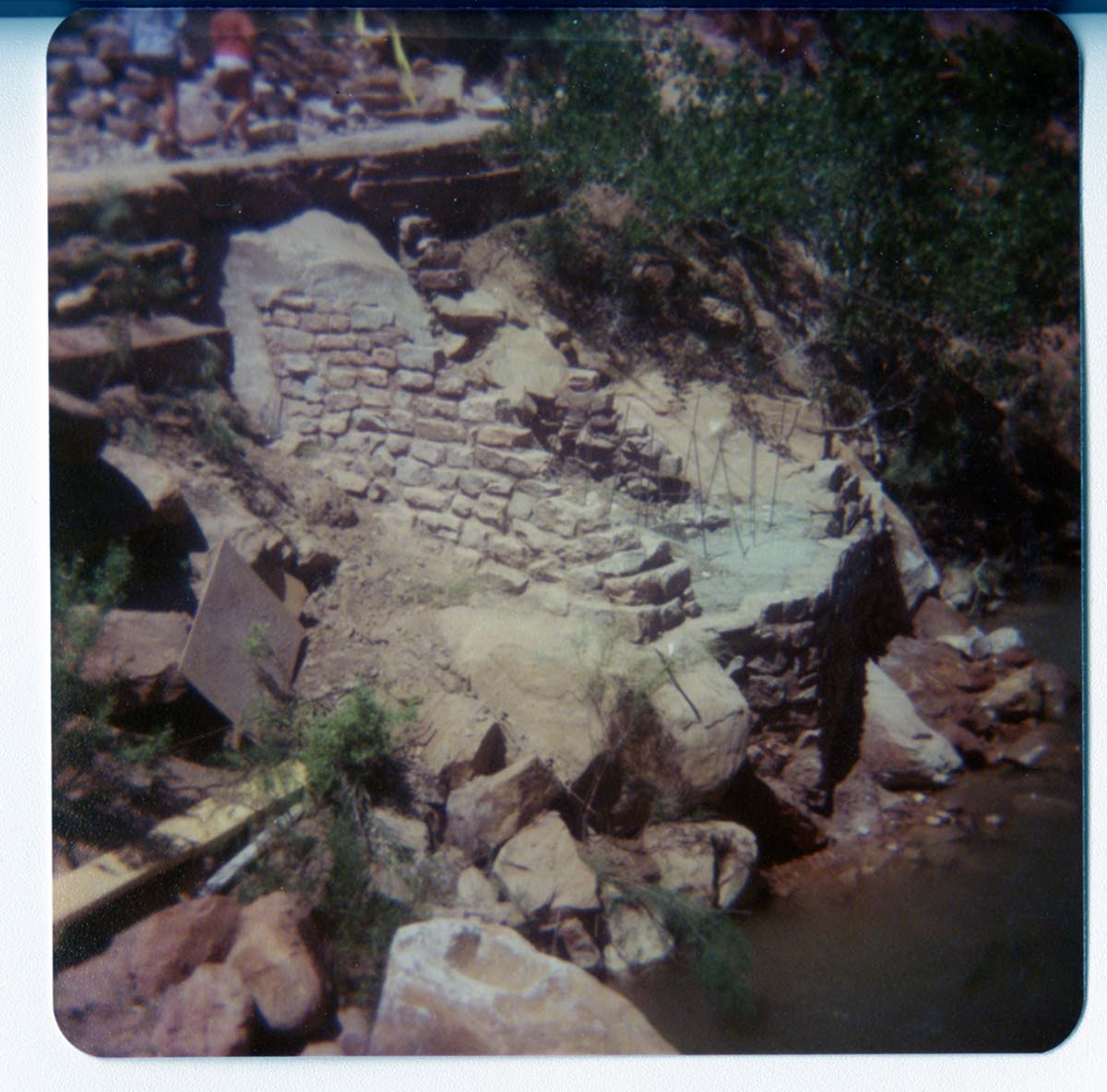 Stone and cement abutment in progress along Virgin River, built for new Grotto footbridge.