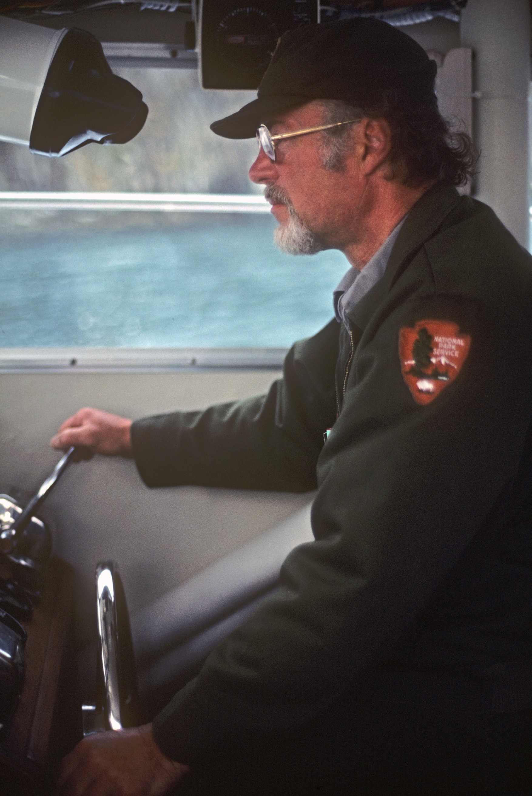 NPS employee, Bill Stevens at the helm of NPS boat "Kenai Ranger"