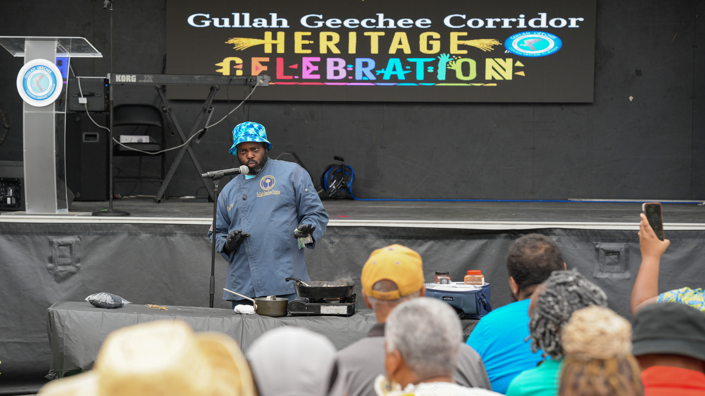 A chef doing a cooking demonstration in front of a crowd.