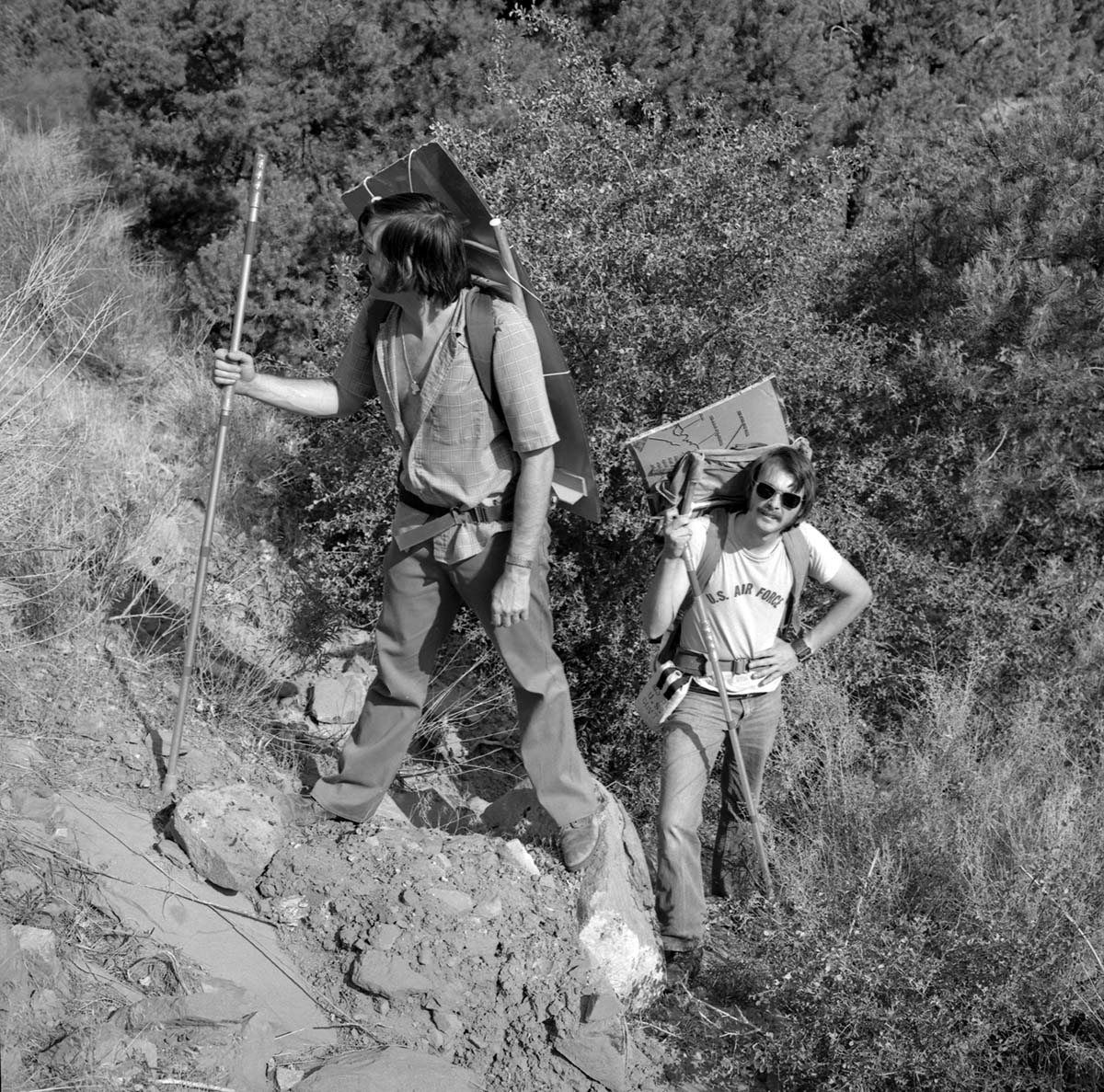 National park technician R. Wood and Zion Natural History Association (ZNHA) employee K. Mansor retrieving vandalized interruptive plaque (Canyon Overlook) from Pine Creek.