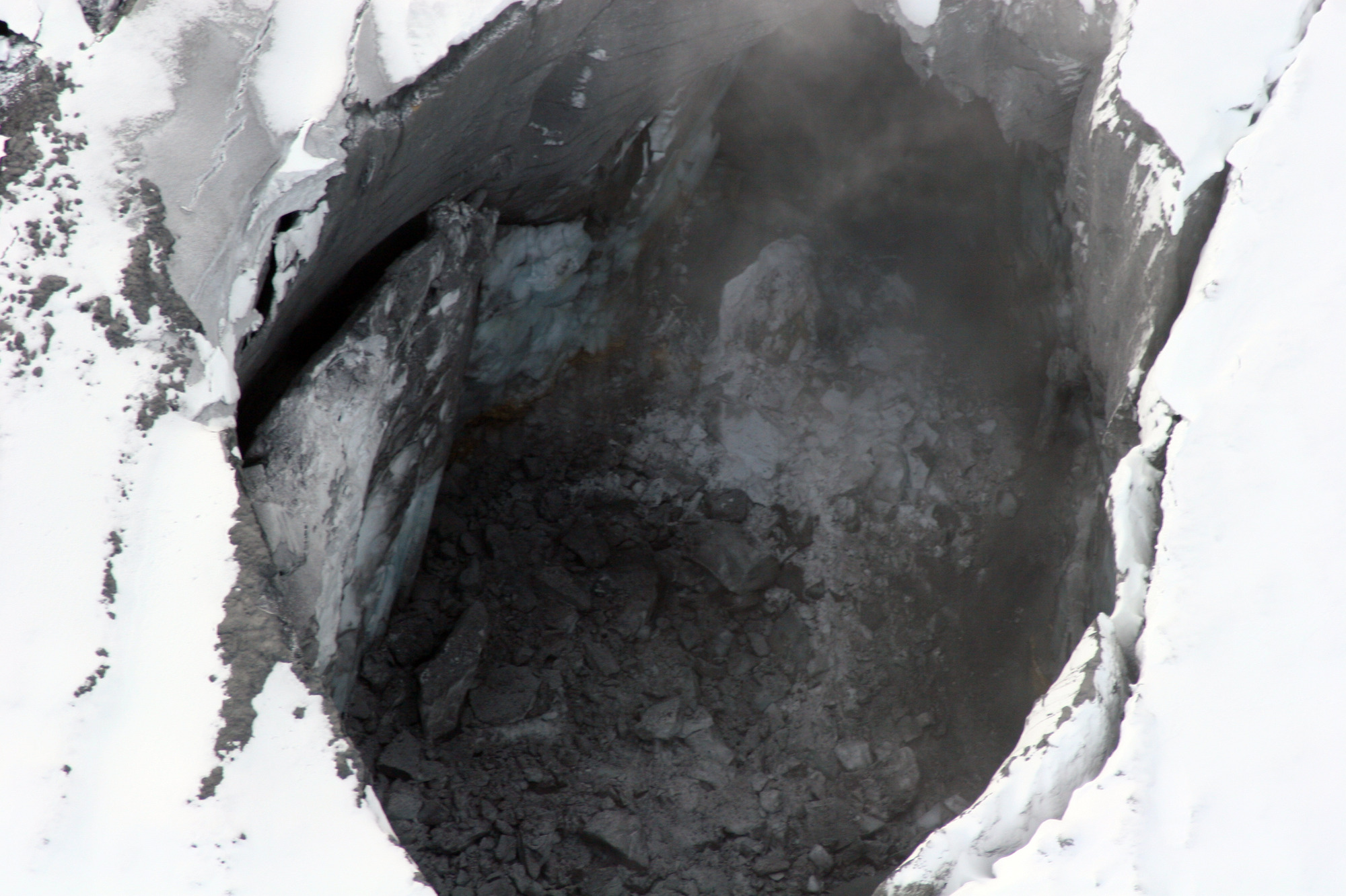 Photograph of a non-venting fumarole pit in glacier ice on the summit of Fourpeaked Mountain.