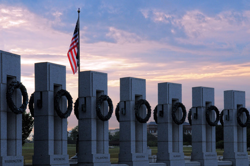 Columns of the World War II Memorial with American flag in the background