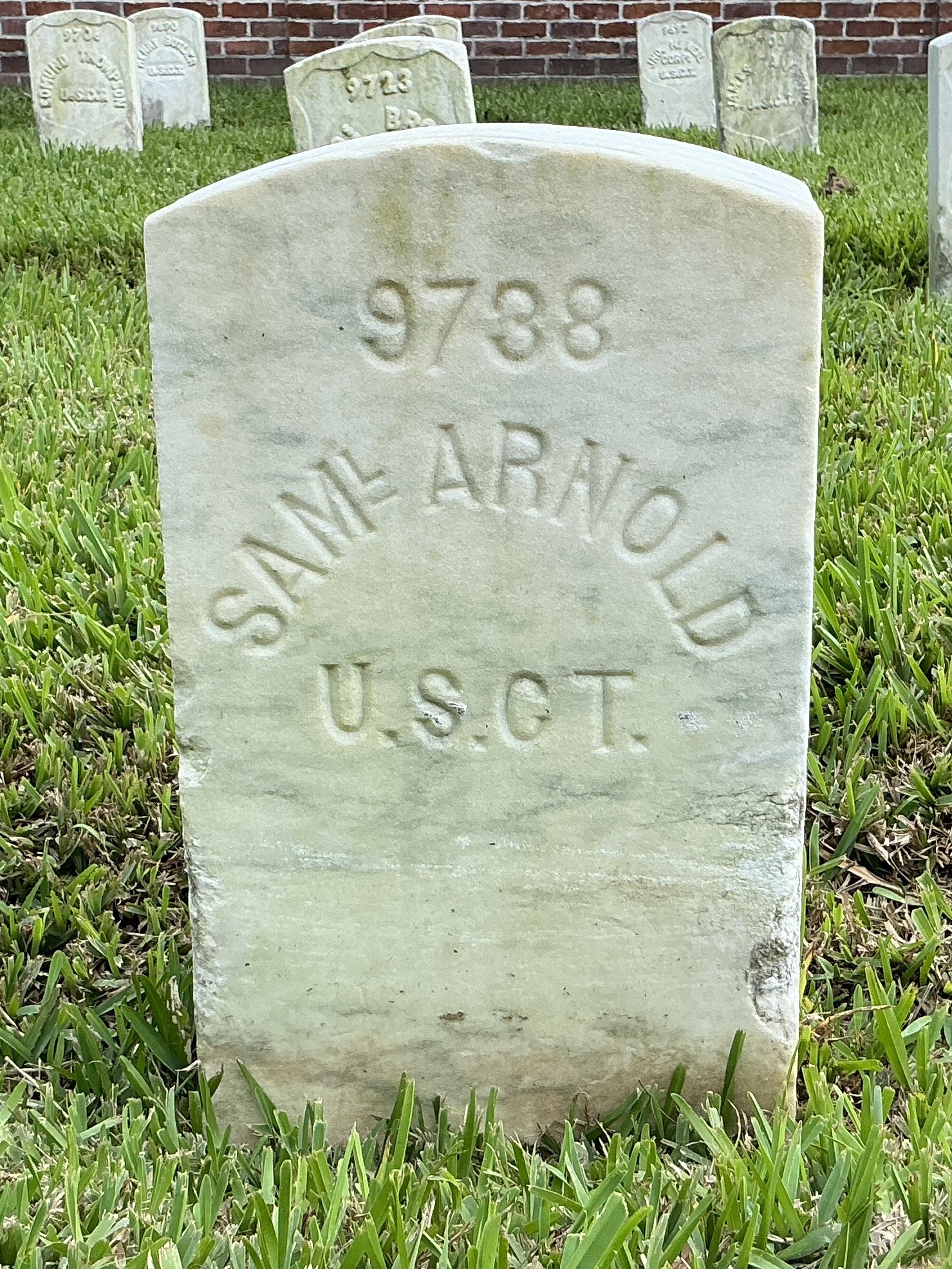 Front of historic upright marble headstone with flat face.