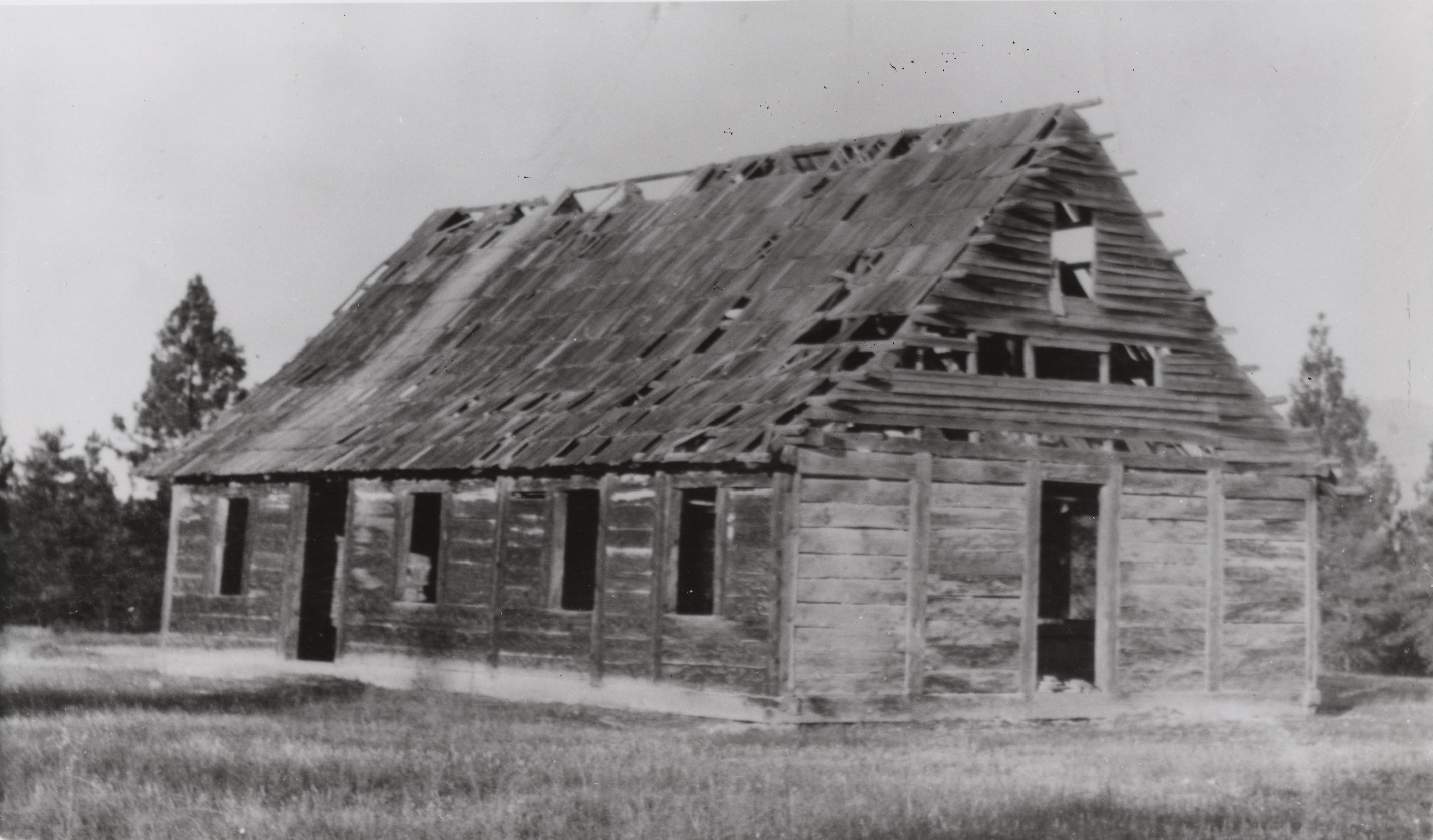 Black and white photograph of dilapidated wooden building