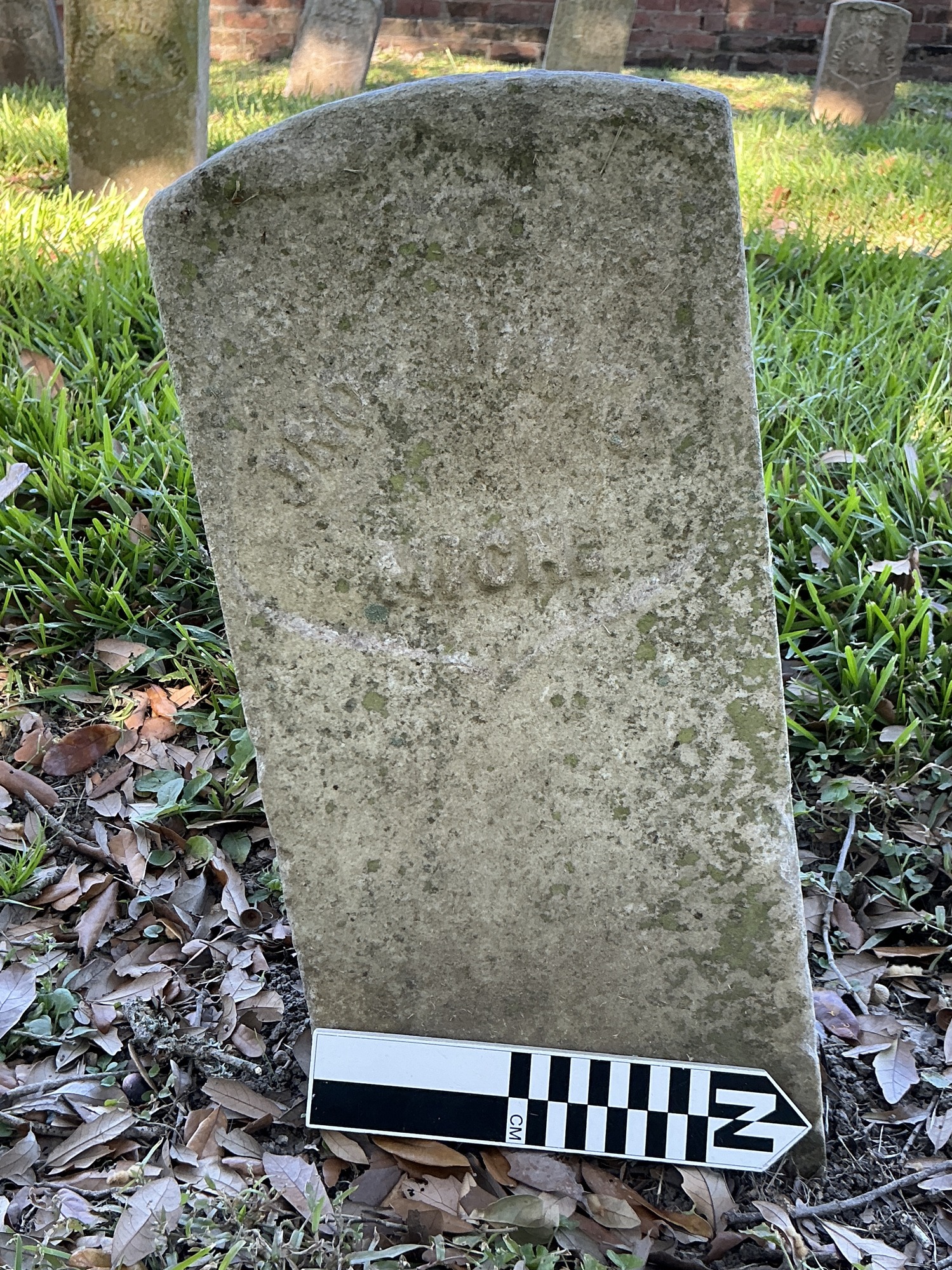 Extra image of historic upright marble headstone with recessed shield face.